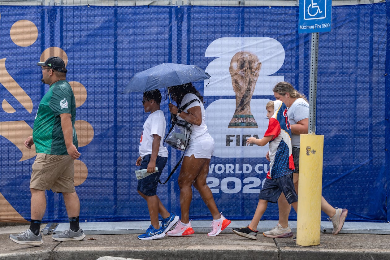 Soccer fans don't let the rain stop them as they head to Atlanta Stadium for the South Africa-Czechia World Cup match on Thursday, June 18, 2026. Storms in North Georgia may linger into the week before Atlanta hosts the Argentina-England semifinal match. (Ben Hendren for the AJC)