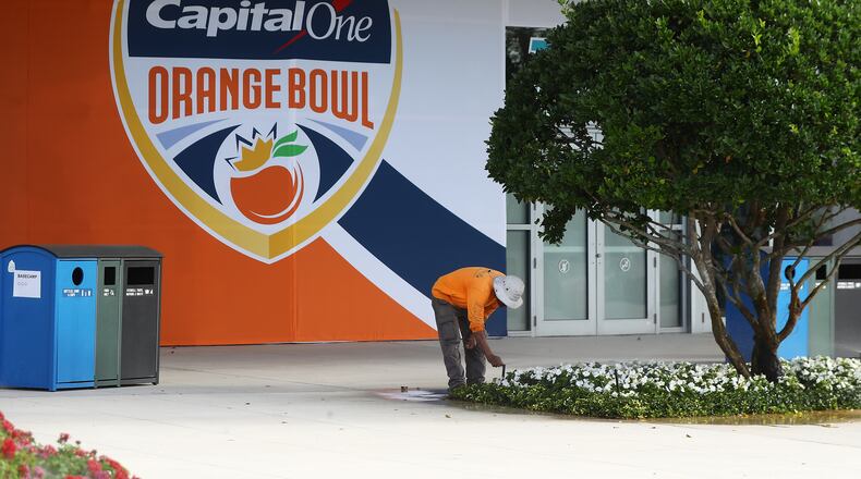 122921 Miami Gardens: A worker tends to a flower bed outside Hard Rock Stadium on Wednesday, Dec 29, 2021, where Georgia will play Michigan in the Orange Bowl CFP Semifinal in Miami Gardens. “Curtis Compton / Curtis.Compton@ajc.com”`