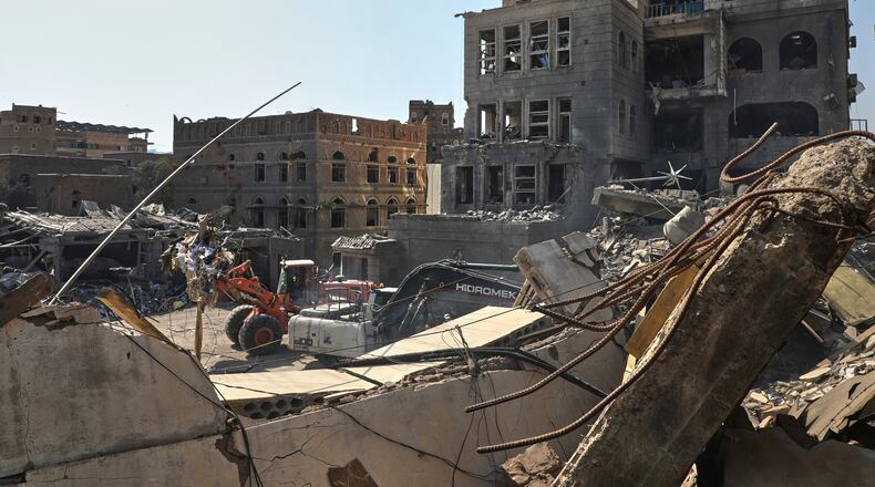 FILE - Workers use heavy machinery to clear rubble from buildings destroyed in an Israeli airstrike in Sanaa, Yemen, on Sept. 13, 2025. (AP Photo/Osamah Abdulrahman, File)