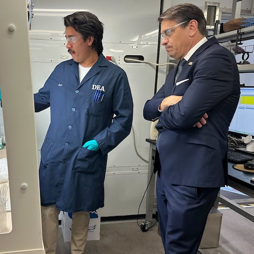 Acting Attorney General Todd Blanche talks to a technician in a Drug Enforcement Administration (DEA) mobile lab who is running tests on seized drugs in Phoenix, Wednesday, May 6, 2026. (AP Photo/Rebecca Santana)