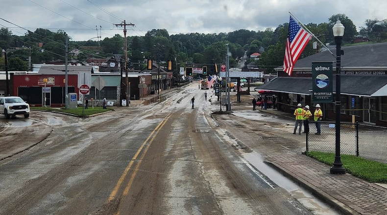 City and county crews and residents in McCaysville clean up streets and repair roads and buildings on Sunday, Aug. 2, 2026, after heavy rainfall overnight and flooding in the North Georgia town. (Courtesy of Fannin County Fire Department)