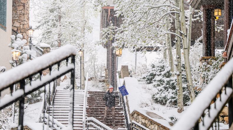 Chris Osborne shovels snow Wednesday, May 6, in Beaver Creek, Colo. (Chris Dillmann/Vail Daily via AP)