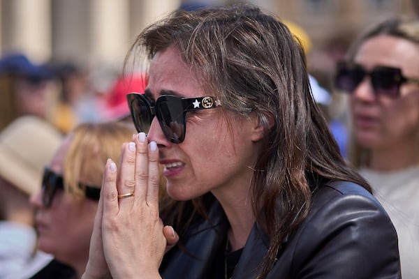 A faithful reacts during the funeral of Pope Francis in St. Peter's Square at the Vatican, Saturday, April 26, 2025. (AP Photo/Emilio Morenatti)