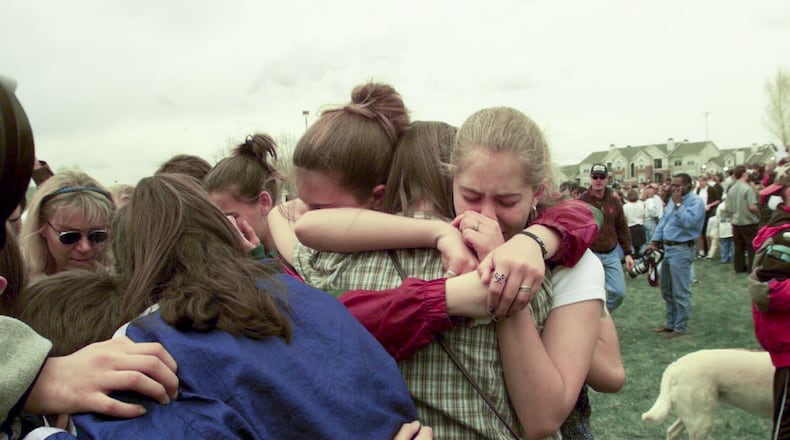 Students the day after the mass shooting at Columbine High School in Littleton, Colo., April 21, 1999. That year, the Columbine High School massacre felt like an earthquake, but as of 2017, it is no longer one of the 10 deadliest mass shootings in postwar America. (Monica Almedia/The New York Times)