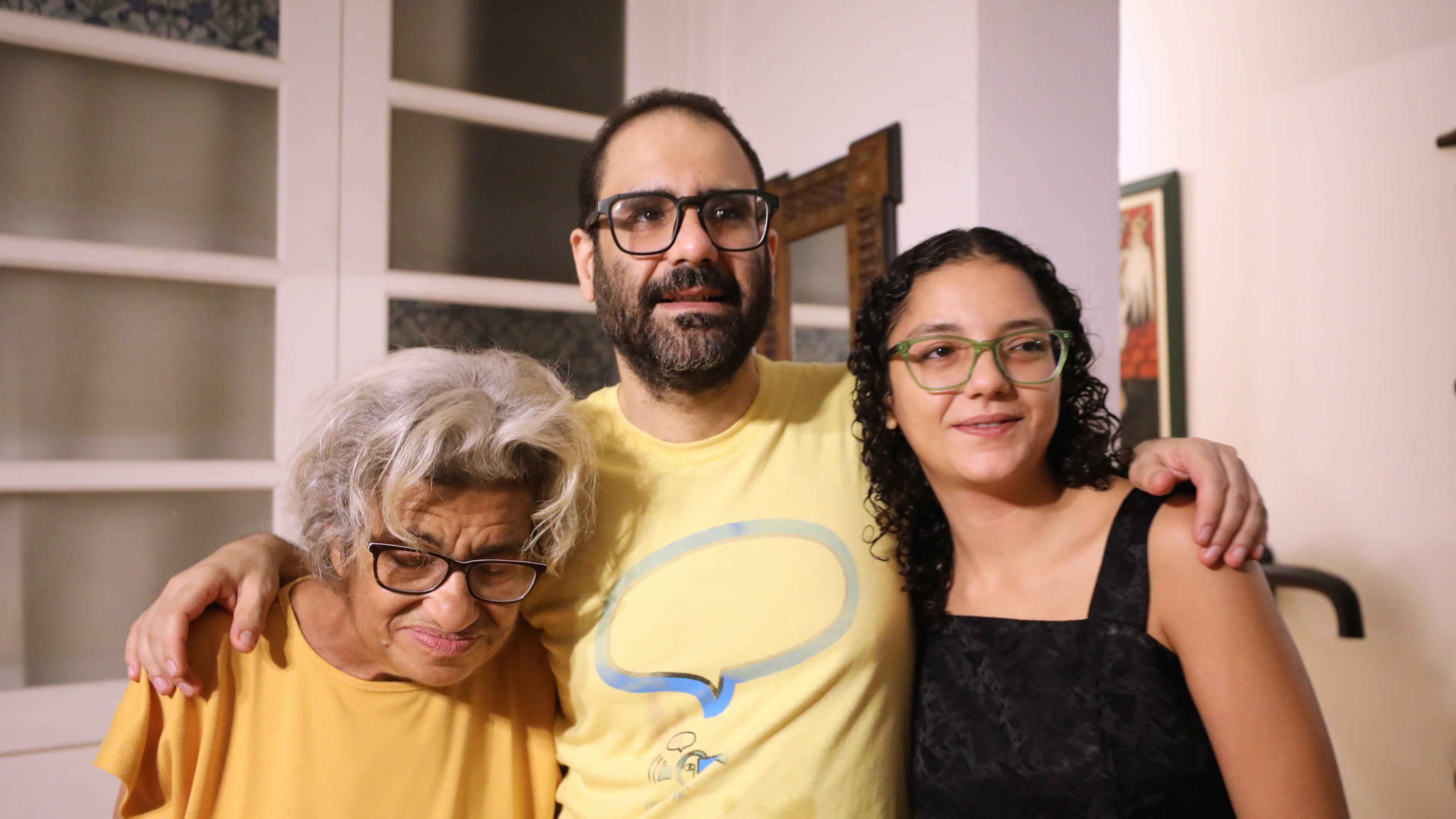 Pro-democracy activist Alaa Abd el-Fattah, who was in prison for almost all of the past 12 years, hugs his mother Laila Soueif and his sister Sanaa Seif at his home after a presidential pardon in Cairo, Tuesday, Sept. 23, 2025. (AP Photo/Khaled Elfiqi)