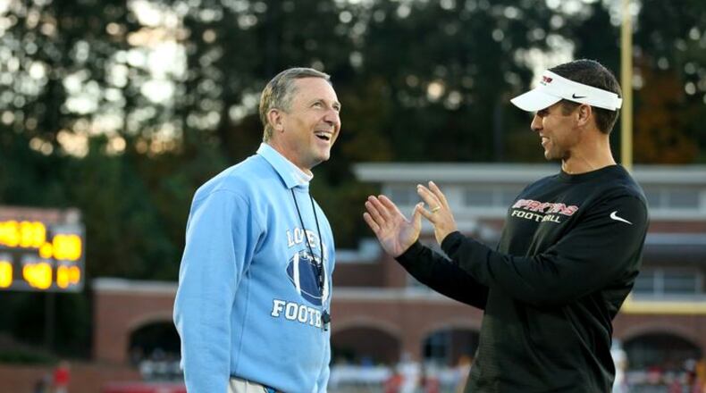 October 30, 2015 - Norcross, Ga: Lovett head coach Mike Muschamp, left, talks with GAC head coach Tim Hardy before their teams play each other at Greater Atlanta Christian Friday in Norcross, Ga., October 30, 2015. PHOTO / JASON GETZ