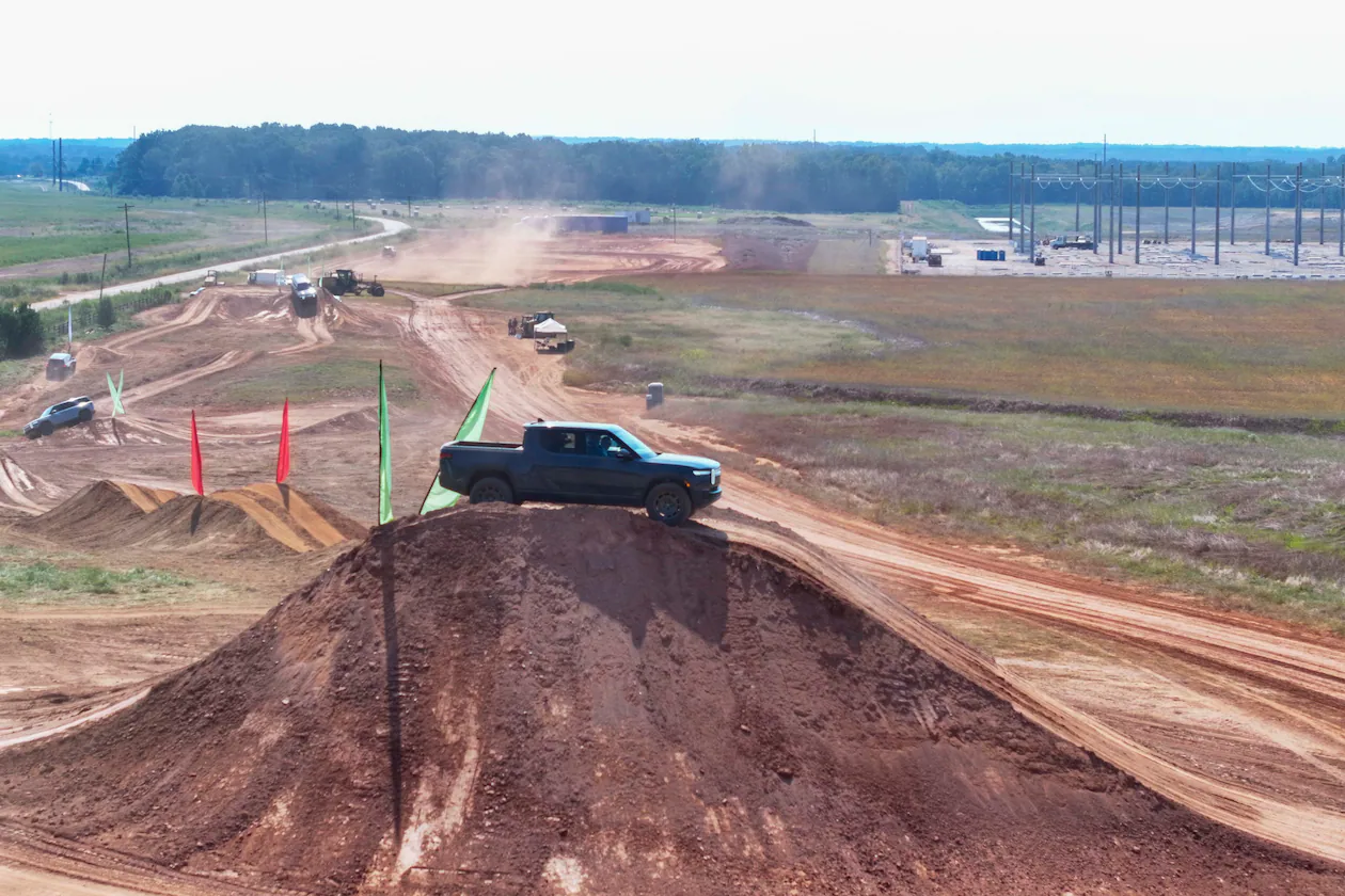 An aerial image shows a Rivian pickup truck on top of a dirt mound during a demonstration after the groundbreaking ceremony on Tuesday, Sept. 16, 2025, in Walton and Morgan Counties. (Miguel Martinez/AJC)
