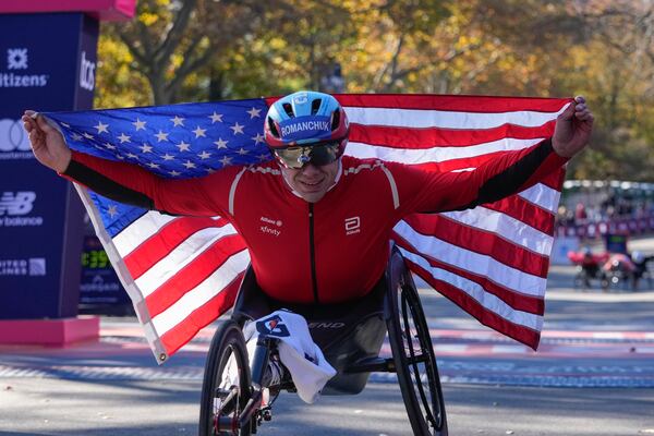FILE - Daniel Romanchuk poses for photos after winning the men's wheelchair division of the New York City Marathon, Nov. 3, 2024, in New York. (AP Photo/Frank Franklin II, File)