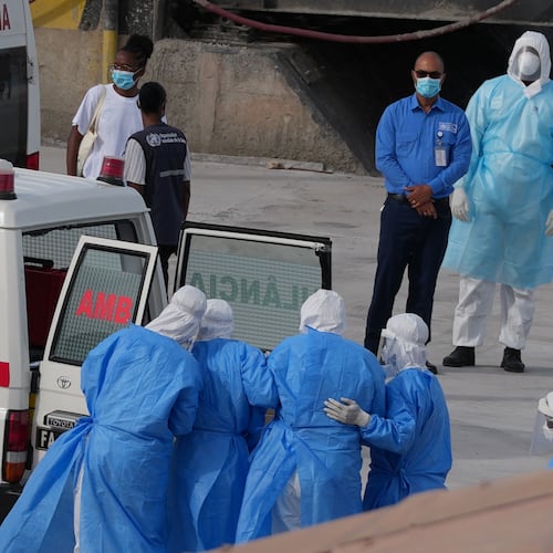 Health workers in protective gear evacuate patients from the MV Hondius cruise ship into an ambulance at a port in Praia, Cape Verde, Wednesday, May 6, 2026. (AP Photo/Misper Apawu)