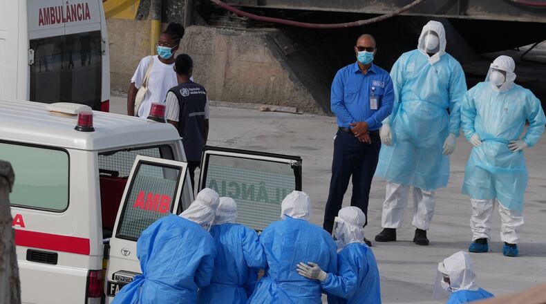 Health workers in protective gear evacuate patients from the MV Hondius cruise ship into an ambulance at a port in Praia, Cape Verde, Wednesday, May 6, 2026. (AP Photo/Misper Apawu)