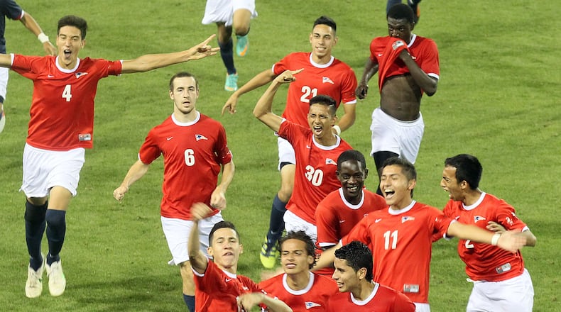 MAY 18, 2013-KENNESAW:Berkmar players run across the field to celebrate their first state championship victory against Collins Hills after their GHSA AAAAAA Boys state soccer match at the Kennesaw State University stadium on Saturday May 18th, 2013. PHIL SKINNER / PSKINNER@AJC.COM