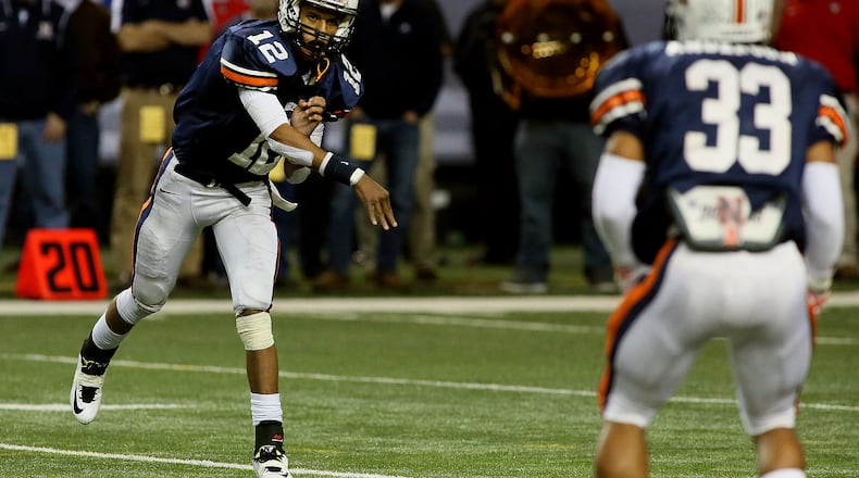 Northside-Warner Robins quarterback Tobias Oliver throws to T.J. Anderson in the first-half action against Mays in their Georgia High School Association AAAAA football state championship game at the Georgia Dome on Friday, Dec. 12, 2014. (Photo by Phil Skinner / AJC file)