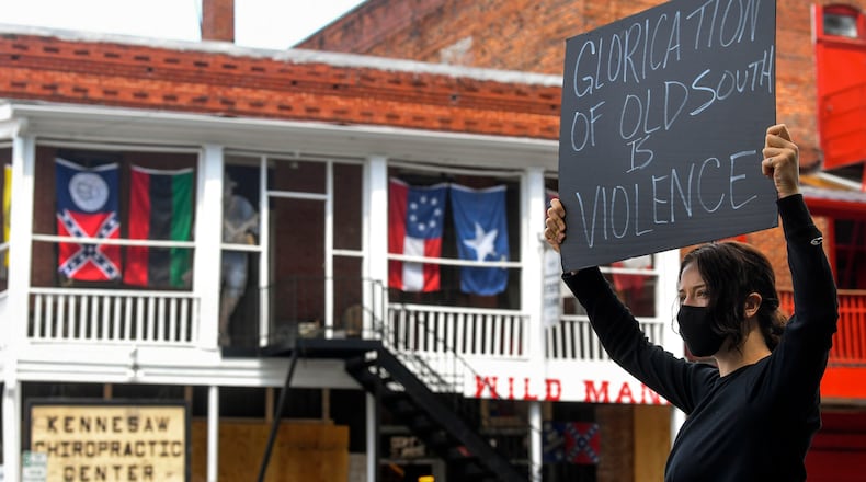 Chelsea Shag demonstrates across the street from a Confederate-era memorabilia shop, during a protest held Friday, June 5, 2020, in Kennesaw. Protests around the nation are occuring to sound off against the killing of George Floyd in Minneapolis police custody. JOHN AMIS FOR THE ATLANTA JOURNAL-CONSTITUTION