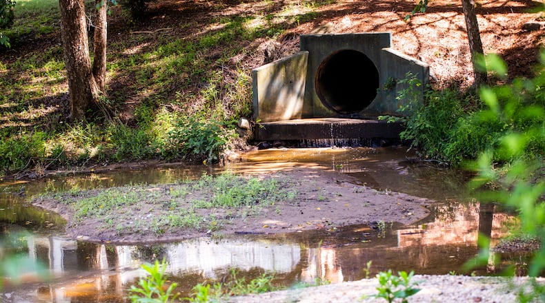 Medlock Bridge subdivision in Johns Creek is an example of the stormwater runoff and erosion issues largely left unaddressed since Johns Creek formally became a city. The silt removed at a cost of half a million dollars paid for by the Medlock Bridge Homeowners Association has returned to the detention pond; flooding of the community’s soccer fields and tennis courts happens a couple times every year. (Jenni Girtman for The Atlanta Journal-Constitution)