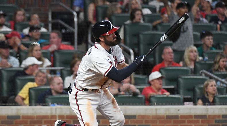Braves shortstop Dansby Swanson (7) hits a 2-RBI single in the 6th inning at Truist Park on Saturday, April 23, 2022. (Hyosub Shin / Hyosub.Shin@ajc.com)