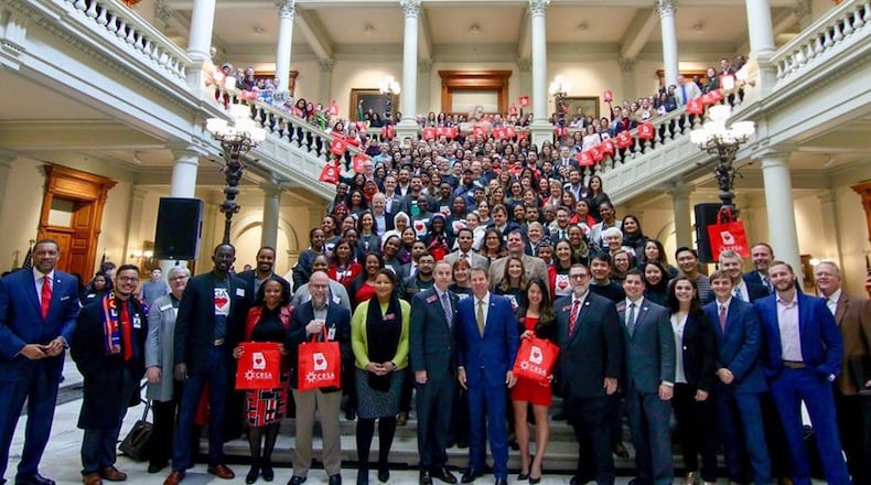 Gov. Brian Kemp, center,  posing with former refugees at a “new Americans” celebration at the state Capitol on Valentine’s Day last February. Photo by  Joseph McBrayer for the Coalition of Refugee Service Agencies.