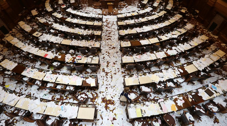Rep. Michele Henson (D-Stone Mountain) heads to her desk in the legislation-covered House chamber early Friday morning March 21, 2014 shortly after the Legislative session ended. BEN GRAY / BGRAY@AJC.COM