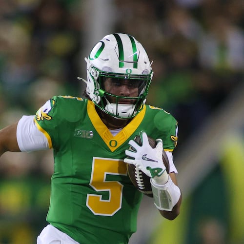 Oregon quarterback Dante Moore (5) runs the ball during the first half of an NCAA college football game against Minnesota Friday, Nov. 14, 2025, in Eugene, Ore. (AP Photo/Lydia Ely)
