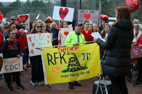 CDC alums listen to a speaker as they mark the one-year anniversary of the first CDC mass firings outside of the organization's headquarters on Clifton Road in Atlanta on Tuesday, Feb. 10, 2026. (Jason Getz/AJC)
