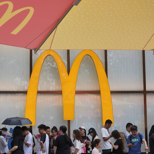 FILE - People line up to enter a McDonald's restaurant in Beijing on Aug. 20, 2025. (AP Photo/Andy Wong, File)