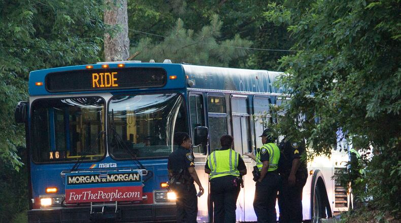 Investigators work the scene where a motorcyclist was killed after being involved in a fatal crash with a MARTA bus on Washington Road on Thurs., June 2, 2016, in East Point. BRANDEN CAMP / SPECIAL