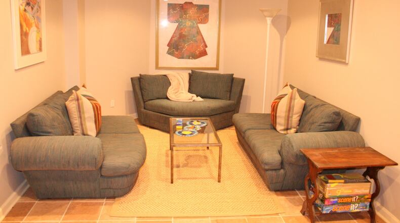 Hanging spare artwork and separating the existing sectional into individual pieces makes the space feel airy and bright. (Handout/TNS)