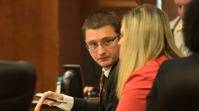 Joseph Rosenbaum (center) speaks with his wife Jennifer (right) during their trial in front of Henry County Chief Judge Brian Amero at the Henry County Superior courthouse, Thursday, July 11, 2019.