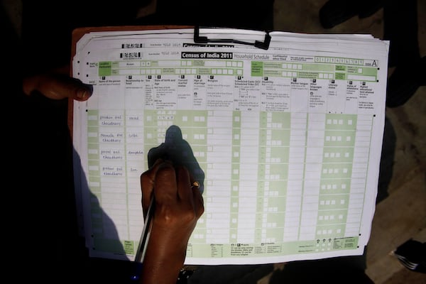 FILE -A census official collects information from a household in Bonda, on the outskirts of Gauhati, India, Feb. 11, 2011. (AP Photo/Anupam Nath, File)
