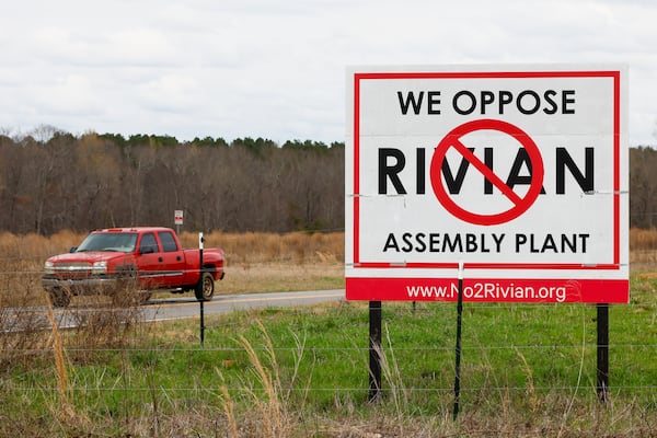 A view of a sign opposing a Rivian factory project in southern Walton and Morgan counties. (Arvin Temkar/AJC 2024)