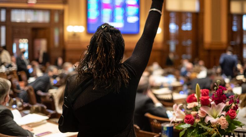 Rep. Park Cannon (D-Atlanta) raises her fist in protest as the House passes a measure that would have required drivers to learn "best practices" on how to interact with police during traffic stops on the final day of the 2021 Legislative session Wednesday, March 31, 2021. The bill ultimately failed. Ben Gray for the Atlanta Journal-Constitution