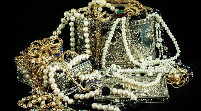An 80-year-old woman was robbed of more than $18,000 of jewelry after agreeing to help two people who claimed they needed help redeeming a lottery ticket.