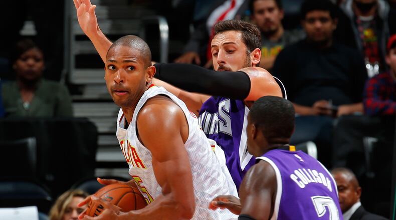 Al Horford (15) of the Atlanta Hawks looks to drive against Marco Belinelli (3) and Darren Collison (7) of the Sacramento Kings at Philips Arena on November 18, 2015 in Atlanta, Georgia. (Photo by Kevin C. Cox/Getty Images)