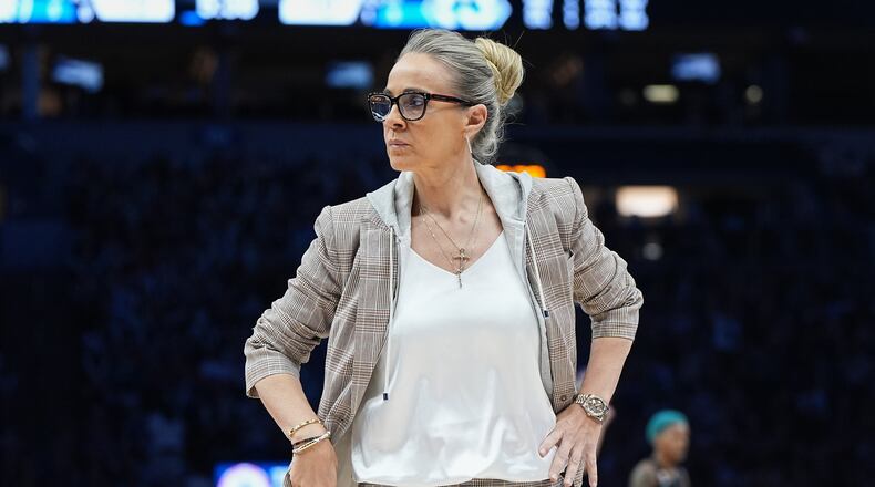 Las Vegas Aces head coach Becky Hammon stands on the court during a timeout in the first half of a WNBA basketball game against the Minnesota Lynx Saturday, Aug. 8, 2026, in Minneapolis. (AP Photo/Abbie Parr)