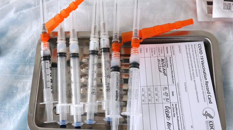 010721 DORAVILLE: Moderna COVID-19 vaccines sit on a tray as they are prepared to be administered to health care workers at the DeKalb COVID-19 BrandsMart USA drive through testing site on Thursday, Jan. 7, 2021, in Doraville.   Curtis Compton / Atlanta Journal-Constitution.
