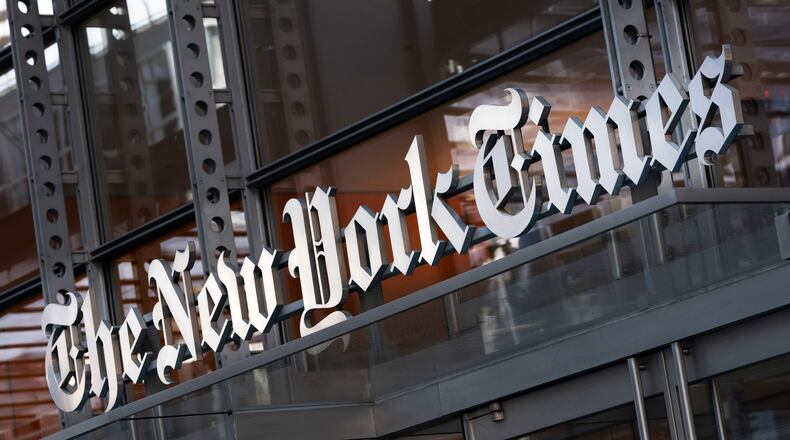 FILE - A sign for The New York Times is displayed above the entrance to its building in New York on May 6, 2021. (AP Photo/Mark Lennihan, File)