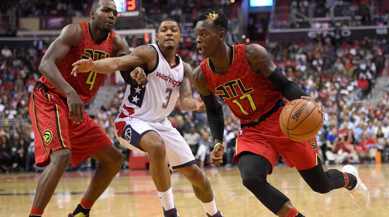 Atlanta Hawks guard Dennis Schroder, of Germany, (17) dribbles against Washington Wizards guard Bradley Beal (3) during the second half in Game 5 of a first-round NBA basketball playoff series, Wednesday, April 26, 2017, in Washington. Also seen is Atlanta Hawks forward Paul Millsap (4). The Wizards won 103-99. (AP Photo/Nick Wass)
