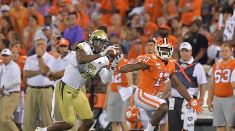 Georgia Tech defensive back Tre Swilling (3) intercepts a pass intended for Clemson wide receiver Cornell Powell (17) and then runs with the ball in the first half at Memorial Stadium on the Clemson University campus in Clemson, S.C. on Thursday, August 29, 2019. Georgia Tech took the field for the first time with Geoff Collins as head coach. (Hyosub Shin / Hyosub.Shin@ajc.com)
