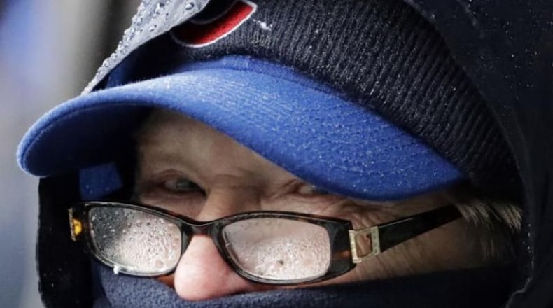 A Cubs fan bundled up for Saturday’s game at Wrigley Field. (AP photo)