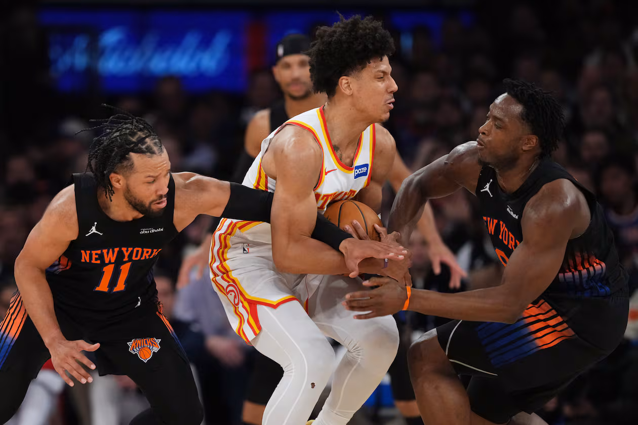 Hawks forward Jalen Johnson (center) is caught between Knicks guard Jalen Brunson (left) and forward OG Anunoby during Game 5 of a first-round NBA playoffs series on Tuesday, April 28, 2026, in New York. Johnson says he’s confident the Hawks will be going back to New York for a deciding Game 7 on Saturday. (Frank Franklin II/AP)