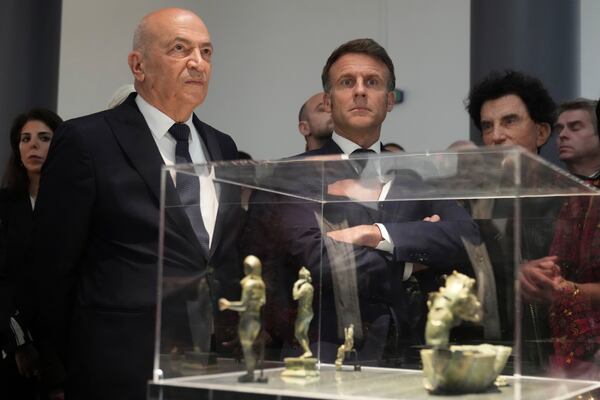 French President Emmanuel Macron, center, and Hani al-Hayek, left, the Palestinian Authority's minister for heritage and tourism, visit the exhibition "Treasures rescued from Gaza" Monday, April 14, 2025 at the Arab World Institute (IMA) in Paris. (AP Photo/Michel Euler, Pool)