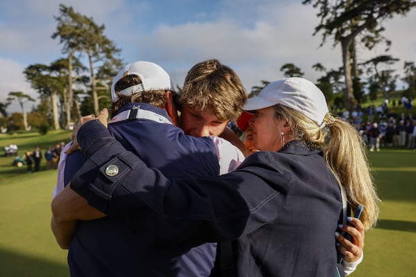 Mason Howell hugs his family after winning the 2025 U.S. Amateur at The Olympic Club on Sunday, Aug. 17, 2025, in San Francisco. He returned Wednesday morning to the Brookwood School in Thomasville. (Chris Keane/USGA)