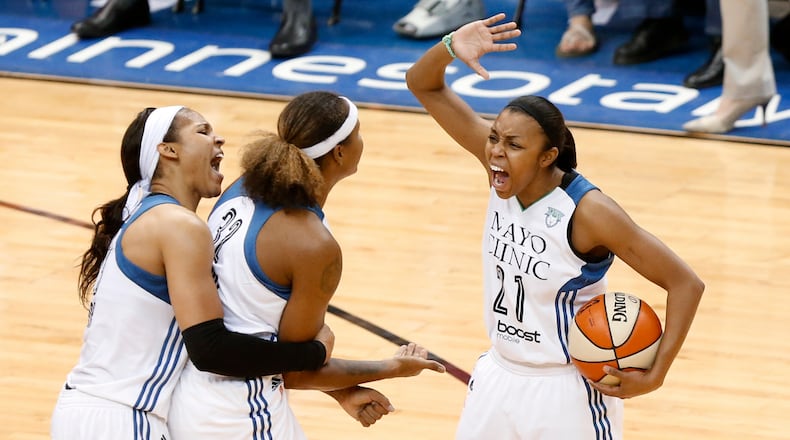FINALS CELEBRATION--Minnesota Lynx forward Maya Moore from left, forward Rebekkah Brunson and Renee Montgomery (21) celebrate against the Indiana Fever in the second half of Game 5 of the WNBA basketball finals, Wednesday, Oct. 14, 2015, in Minneapolis. (AP Photo/Stacy Bengs)