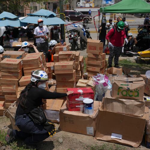 Rescue workers sort humanitarian aid for earthquake survivors in La Guaira, Venezuela, Thursday, July 2, 2026. (AP Photo/Matias Delacroix)