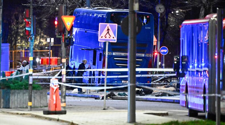 A double-decker bus crashed into a bus shelter in Stockholm on Friday, Nov. 14, 2025, causing fatalities and injuries. (Claudio Bresciani/TT News Agency via AP)