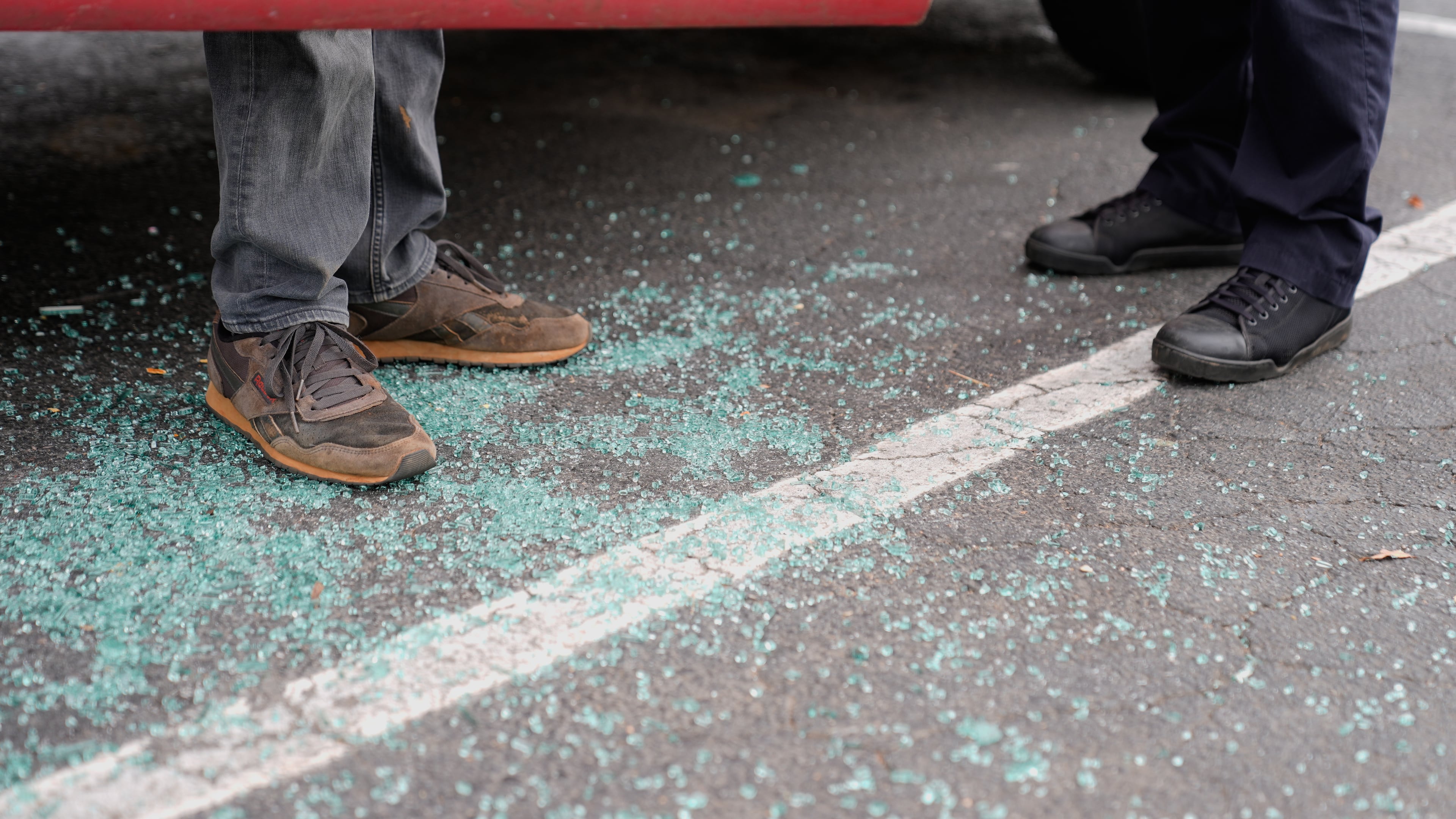 Willy Aceituno, left, makes a police report with Charlotte-Mecklenburg Police Department officer N. Sherill, after U.S. Customs and Border Protection officers broke his window during an enforcement operation, Saturday, Nov. 15, 2025, in Charlotte, N.C. (AP Photo/Erik Verduzco)