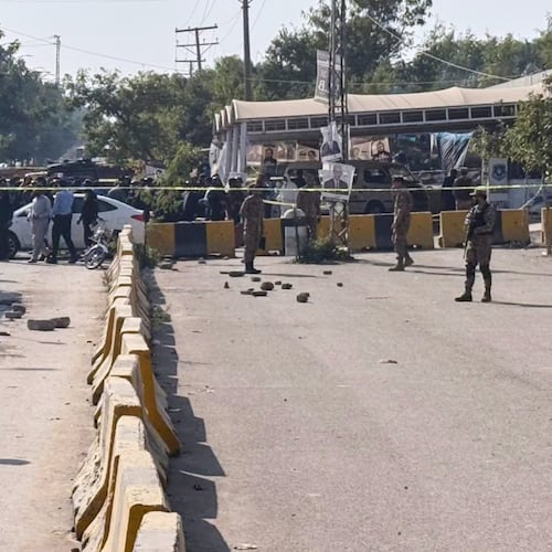 Pakistani security officials stand guard after a powerful car bomb exploded outside a district court in Islamabad, Pakistan, Tuesday, Nov. 11, 2025. (AP Photo/Mohammad Yousuf)