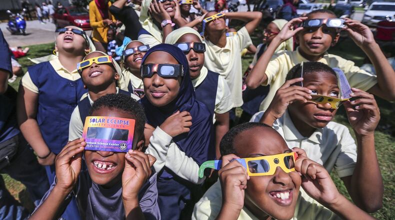 Fourth-graders and fifth-graders from the Mohammed schools of Atlanta watch the eclipse at Fernbank Science Center. JOHN SPINK/JSPINK@AJC.COM