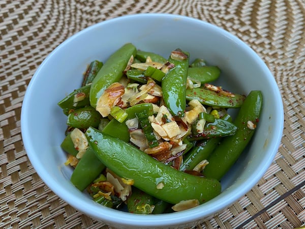 The sugar snap peas on the menu at Tiny Lou's are a springtime play on green beans amandine. Ligaya Figueras/ligaya.figueras@ajc.com