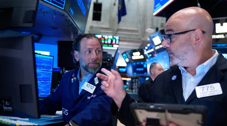 Michael Pistillo, left, and Federico DeMarco work on the floor at the New York Stock Exchange in New York, Monday, July 6, 2026. (AP Photo/Seth Wenig)