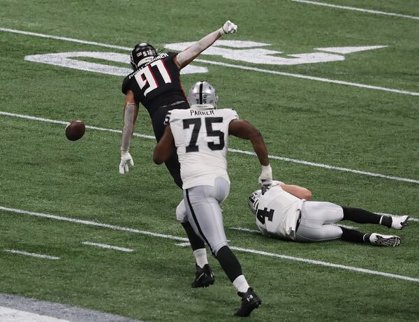 Falcons defensive tackle Jacob Tuioti-Mariner strip sacks Las Vegas Raiders quarterback Derek Carr and recovers the fumble during the second quarter Sunday, Nov. 29, 2020, at Mercedes-Benz Stadium in Atlanta. (Curtis Compton / Curtis.Compton@ajc.com)